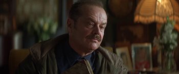 Movie still from “The Pledge” (2001), directed by Sean Penn – An older man with a mustache wearing a tie; Close Up shot, Low angle