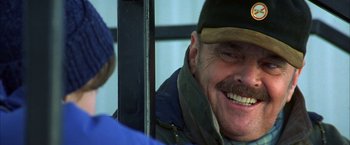 Movie still from “The Pledge” (2001), directed by Sean Penn – A man with a beard and a hat is smiling for the camera; Close Up shot, Over the shoulder angle