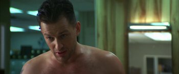 Movie still from “The Pledge” (2001), directed by Sean Penn – A shirtless man in a bathroom looking into a mirror; Close Up shot, Low angle