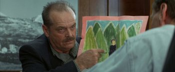 Movie still from “The Pledge” (2001), directed by Sean Penn – An older man looking at a picture of a man in the woods; Close Up shot, Over the shoulder angle