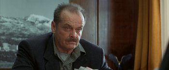 Movie still from “The Pledge” (2001), directed by Sean Penn – An older man with a beard is holding a stack of money; Close Up shot, Low angle