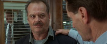 Movie still from “The Pledge” (2001), directed by Sean Penn – A man standing next to another man in front of a window; Close Up shot, Over the shoulder angle