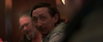 Movie still from “The Pledge” (2001), directed by Sean Penn – A person with long hair; Close Up shot, Over the shoulder angle