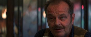 Movie still from “The Pledge” (2001), directed by Sean Penn – An older man with a mustache is sitting in a chair; Close Up shot, Low angle