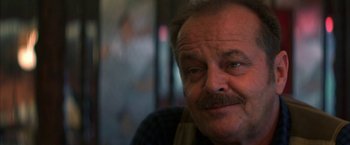 Movie still from “The Pledge” (2001), directed by Sean Penn – An older man with a mustache is looking at the camera; Close Up shot, Over the shoulder angle