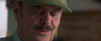 Movie still from “The Pledge” (2001), directed by Sean Penn – A person wearing a hat; Close Up shot, Over the shoulder angle