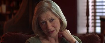 Movie still from “The Pledge” (2001), directed by Sean Penn – An older woman is looking at the camera; Close Up shot, Low angle