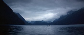 Movie still from “The Pledge” (2001), directed by Sean Penn – A boat in the middle of a body of water; Extreme Wide shot, High angle