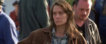 Movie still from “The Pledge” (2001), directed by Sean Penn – A woman with long hair is looking at the camera; Close Up shot, Over the shoulder angle