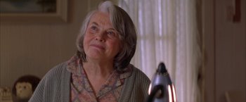 Movie still from “The Pledge” (2001), directed by Sean Penn – An older woman is looking at the reflection of herself in a mirror; Close Up shot, Low angle