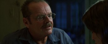 Movie still from “The Pledge” (2001), directed by Sean Penn – An older man wearing glasses and a blue shirt; Close Up shot, Over the shoulder angle