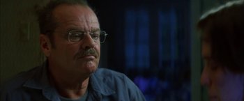 Movie still from “The Pledge” (2001), directed by Sean Penn – An older man wearing glasses and a blue shirt; Close Up shot, Low angle