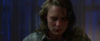 Movie still from “The Pledge” (2001), directed by Sean Penn – A man with a bandage on his face; Close Up shot, Over the shoulder angle