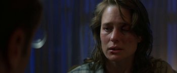 Movie still from “The Pledge” (2001), directed by Sean Penn – A person with her eyes closed; Close Up shot, Over the shoulder angle