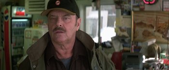 Movie still from “The Pledge” (2001), directed by Sean Penn – A person wearing a hat; Close Up shot, Over the shoulder angle