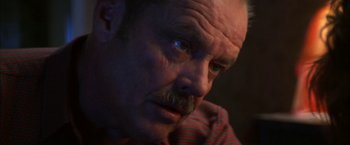 Movie still from “The Pledge” (2001), directed by Sean Penn – A man with a mustache; Close Up shot, Low angle