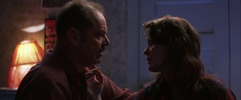 Movie still from “The Pledge” (2001), directed by Sean Penn – A man and a woman face to face in a dark room; Close Up shot, Low angle