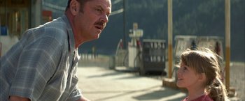 Movie still from “The Pledge” (2001), directed by Sean Penn – A person near a gas pump; Close Up shot, Over the shoulder angle