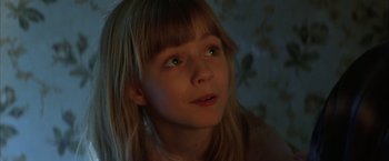 Movie still from “The Pledge” (2001), directed by Sean Penn – A little girl with long blonde hair and green eyes; Close Up shot, Low angle