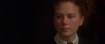 Movie still from “The Portrait of a Lady” (1996), directed by Jane Campion – A person wearing a suit and tie; Close Up shot, Over the shoulder angle