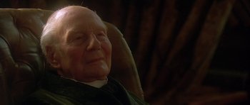 Movie still from “The Portrait of a Lady” (1996), directed by Jane Campion – An old man sitting in a chair with a white beard; Close Up shot, Over the shoulder angle