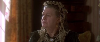 Movie still from “The Portrait of a Lady” (1996), directed by Jane Campion – An older woman wearing a black dress and a lace headpiece; Close Up shot, Low angle