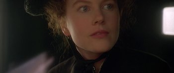 Movie still from “The Portrait of a Lady” (1996), directed by Jane Campion – A person wearing a black shirt and a neck tie; Close Up shot, Over the shoulder angle