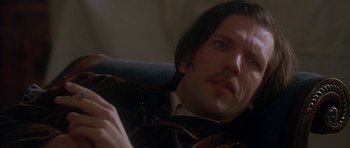 Movie still from “The Portrait of a Lady” (1996), directed by Jane Campion – A person sitting in a chair; Close Up shot, Low angle