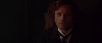 Movie still from “The Portrait of a Lady” (1996), directed by Jane Campion – A person wearing a suit and tie; Close Up shot, Over the shoulder angle