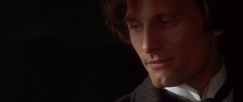 Movie still from “The Portrait of a Lady” (1996), directed by Jane Campion – A person wearing a suit and tie; Close Up shot, High angle