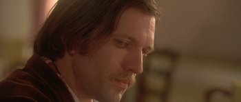 Movie still from “The Portrait of a Lady” (1996), directed by Jane Campion – A person wearing a suit and tie; Close Up shot, Low angle