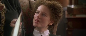 Movie still from “The Portrait of a Lady” (1996), directed by Jane Campion – A person wearing a suit and tie; Close Up shot, Over the shoulder angle