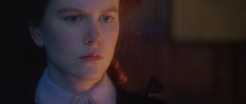 Movie still from “The Portrait of a Lady” (1996), directed by Jane Campion – A young person's face in the dark; Close Up shot, Over the shoulder angle