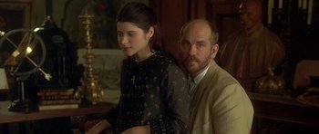 Movie still from “The Portrait of a Lady” (1996), directed by Jane Campion – A man sitting next to a young girl in front of a table; Close Up shot, Over the shoulder angle