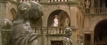 Movie still from “The Portrait of a Lady” (1996), directed by Jane Campion – A man and a woman standing on a balcony; Wide shot, Low angle
