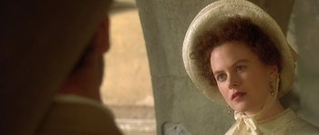 Movie still from “The Portrait of a Lady” (1996), directed by Jane Campion – A woman wearing a straw hat looking into a mirror; Close Up shot, Over the shoulder angle