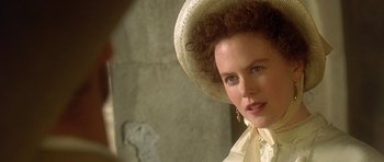 Movie still from “The Portrait of a Lady” (1996), directed by Jane Campion – A woman in a white dress and a white hat; Close Up shot, Over the shoulder angle