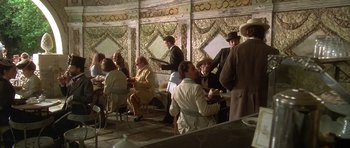 Movie still from “The Portrait of a Lady” (1996), directed by Jane Campion – A group of people sitting around a table; Wide shot, High angle
