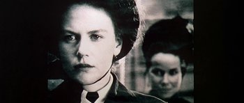 Movie still from “The Portrait of a Lady” (1996), directed by Jane Campion – A woman in a suit and tie next to another woman in a suit and tie; Close Up shot, Over the shoulder angle