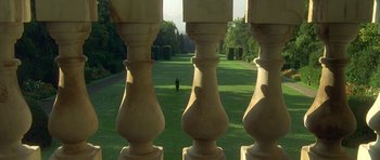 Movie still from “The Portrait of a Lady” (1996), directed by Jane Campion – A person walking in the distance in a park; Extreme Wide shot, Low angle