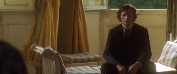 Movie still from “The Portrait of a Lady” (1996), directed by Jane Campion – A man and a woman sitting on a chair in front of a window; Medium shot, Over the shoulder angle