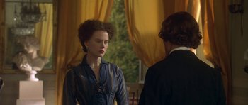 Movie still from “The Portrait of a Lady” (1996), directed by Jane Campion – A woman standing next to a man in front of a window; Medium shot, Over the shoulder angle