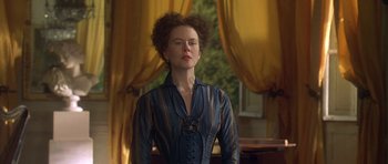 Movie still from “The Portrait of a Lady” (1996), directed by Jane Campion – A woman standing in front of a window with curtains; Medium shot, Low angle