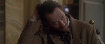 Movie still from “The Portrait of a Lady” (1996), directed by Jane Campion – A person wearing a suit and tie; Close Up shot, Over the shoulder angle