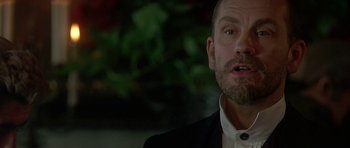 Movie still from “The Portrait of a Lady” (1996), directed by Jane Campion – A person wearing a suit and tie; Close Up shot, Low angle