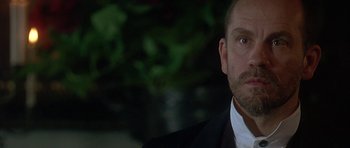 Movie still from “The Portrait of a Lady” (1996), directed by Jane Campion – A person wearing a suit and tie; Close Up shot, Low angle