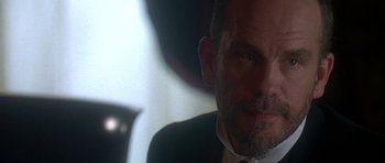 Movie still from “The Portrait of a Lady” (1996), directed by Jane Campion – A person wearing a suit and tie; Close Up shot, Over the shoulder angle