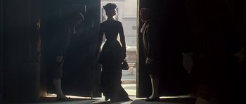 Movie still from “The Portrait of a Lady” (1996), directed by Jane Campion – A woman in a black dress and a man in a black suit; Wide shot, Over the shoulder angle