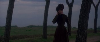 Movie still from “The Portrait of a Lady” (1996), directed by Jane Campion – A woman in a brown dress and a black hat; Medium shot, Low angle