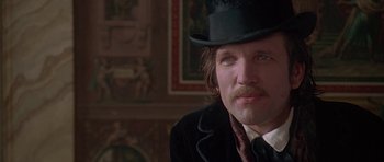 Movie still from “The Portrait of a Lady” (1996), directed by Jane Campion – A person wearing a top hat; Close Up shot, Over the shoulder angle